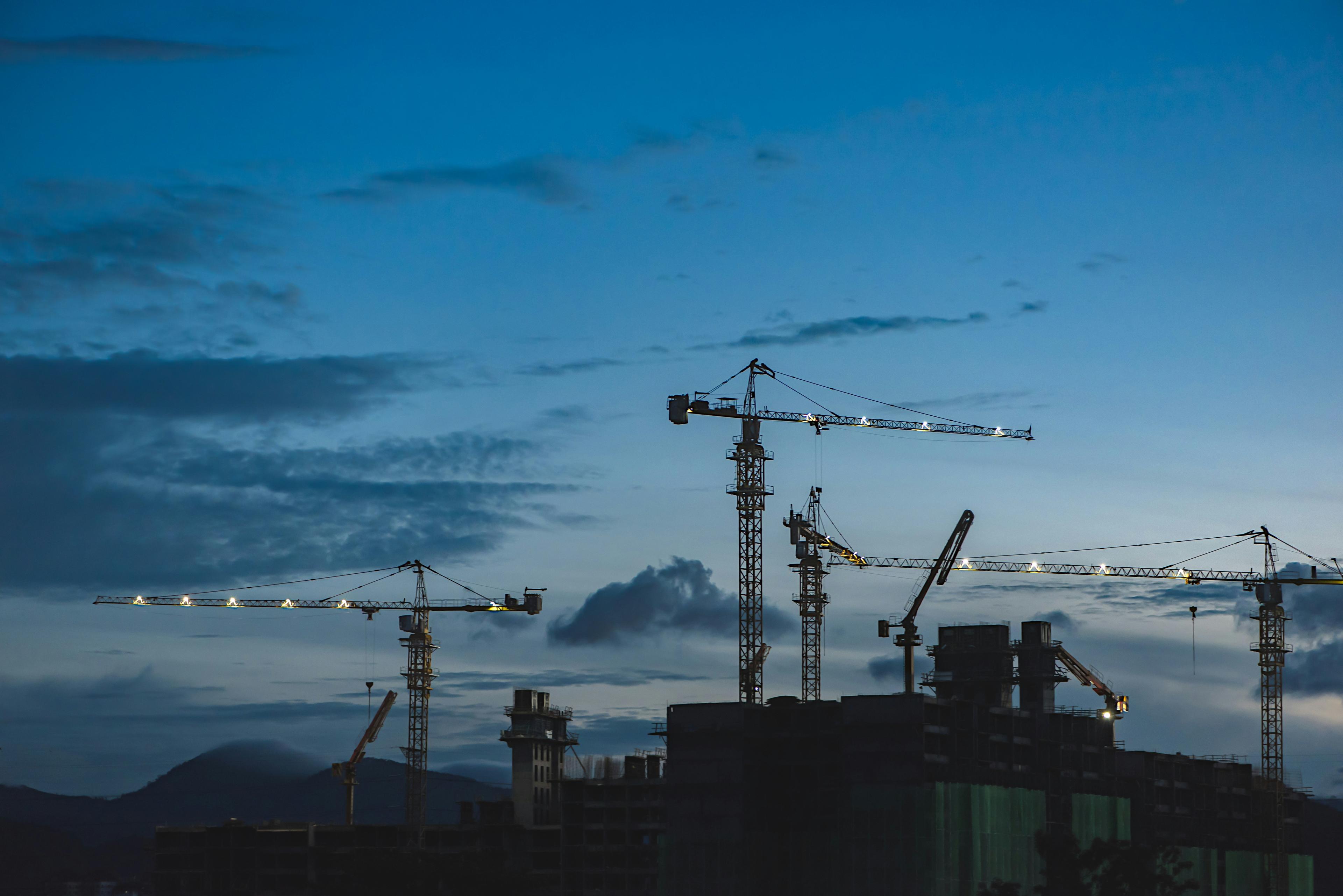 Construction cranes at dusk